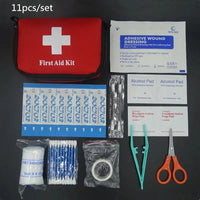 11-piece first aid kit with red survival bag, adhesive wound dressings, alcohol pads, bandages, scissors, tweezers, and cotton swabs.