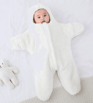 Baby in white plush bear costume on white background