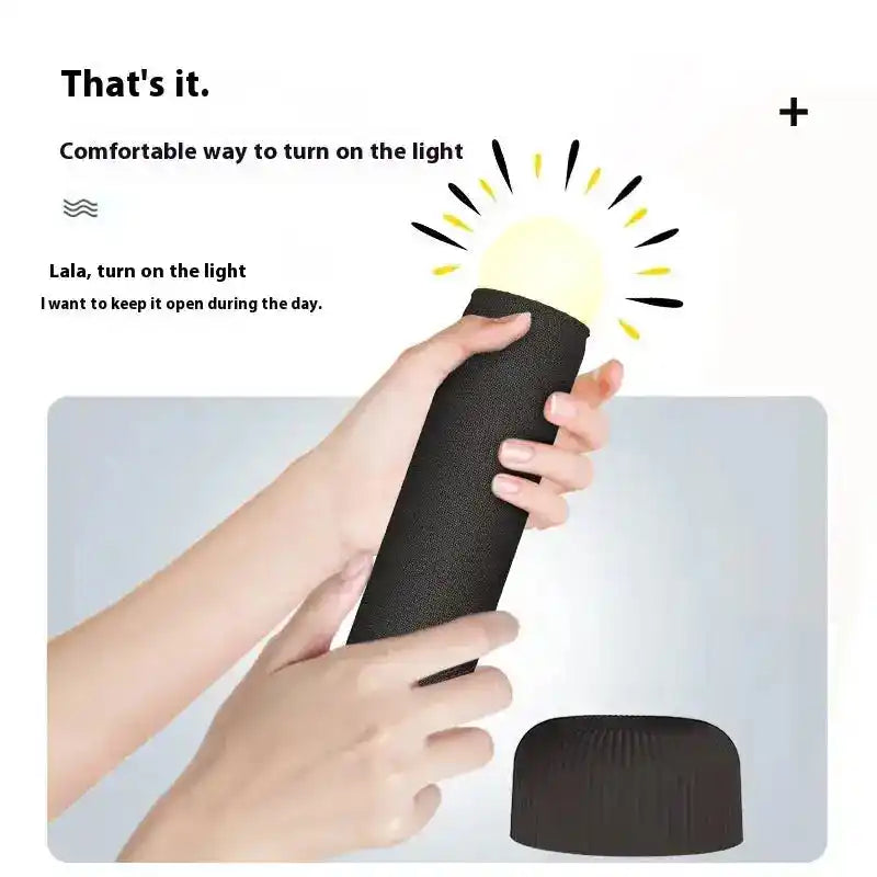 Black hand pull night lamp being held and activated, demonstrating its ergonomic design and soft glowing light for nighttime 