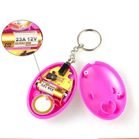 Pink keychain emergency alarm opened to show internal components, including a 23A 12V battery for operation.