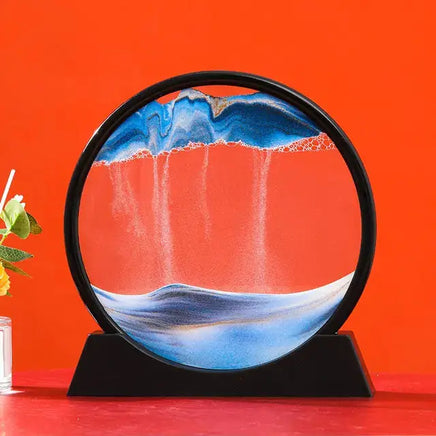 Moving Sand Art Picture Frame with dynamic blue and white sand patterns creating mesmerizing landscapes against a vibrant red background.