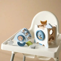 Educational rocket toy disassembled into parts on a high chair, showcasing its interactive and learning-focused design.