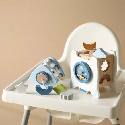 Educational rocket toy disassembled into parts on a high chair, showcasing its interactive and learning-focused design.