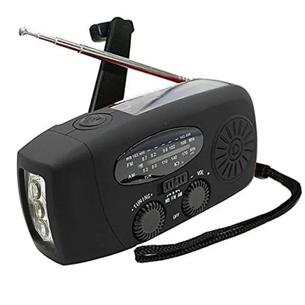 Black portable emergency radio with LED flashlight, AM/FM/WB tuning dials, and hand crank for power.