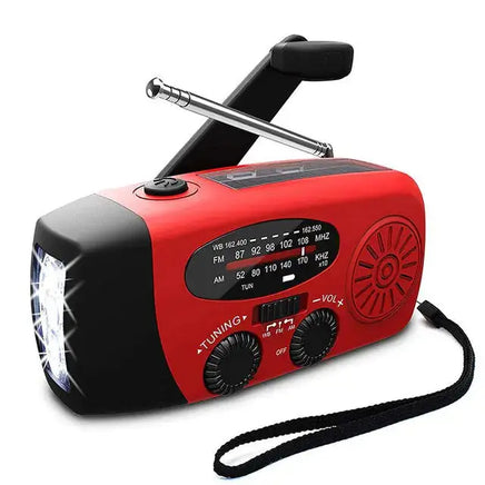 Red emergency radio with LED flashlight, hand crank, and AM/FM/WB tuning dials, designed for outdoor and emergency use.