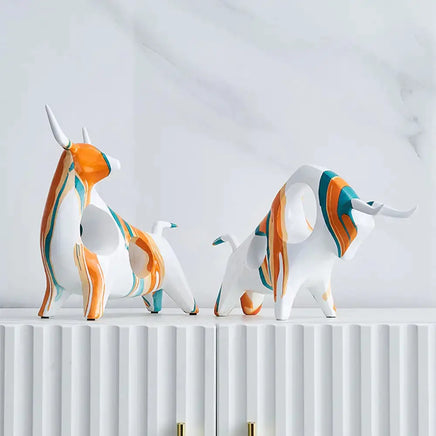 Modern Art Graffiti Cow Figurines with sleek white and orange abstract patterns, perfect for modern interior decoration.