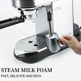 Semi-automatic steam wand milk frother creating rich foam in a stainless steel cup, ideal for home or office use.
