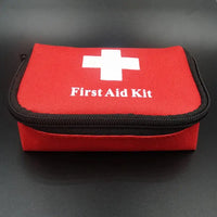 Red first aid kit bag with a white cross and zipper, perfect for compact storage of emergency tools and medical supplies.