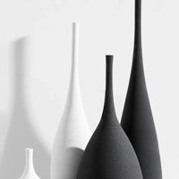 Close-up of black and white Jingdezhen modern minimalist handmade vases showcasing their textured ceramic finish and elegant forms.