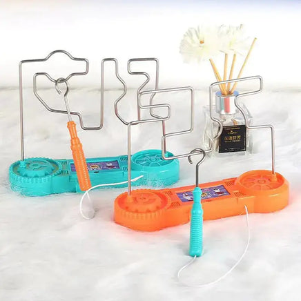 Electric bump maze fire line toy in orange and blue variants, featuring a handheld wand and intricate wire maze design.