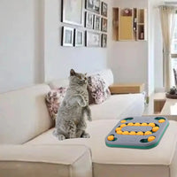 Cat curiously observing a gray and yellow dog puzzle toy on a sofa, showcasing its versatility for pet entertainment.