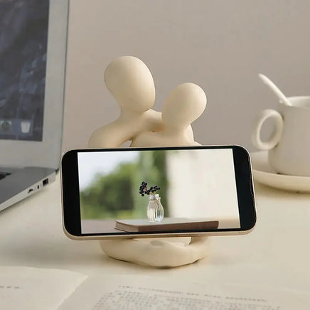 Nordic couple statue functioning as a phone holder, blending practicality with modern decor aesthetics.