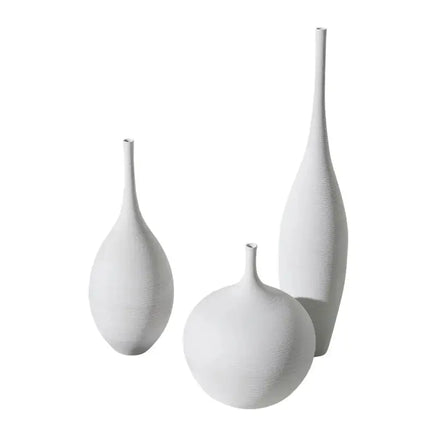 Three white Jingdezhen modern minimalist handmade vases of varying shapes and sizes against a white background.