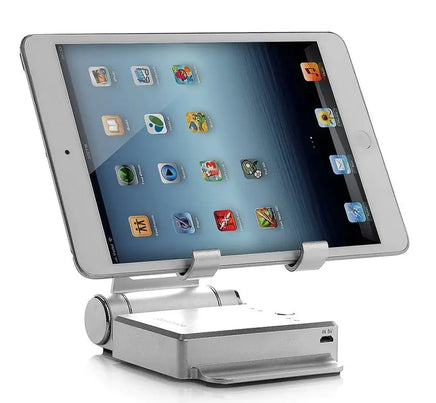 Silver podium style stand holding an iPad, showcasing its adjustable angles and USB charging capabilities.