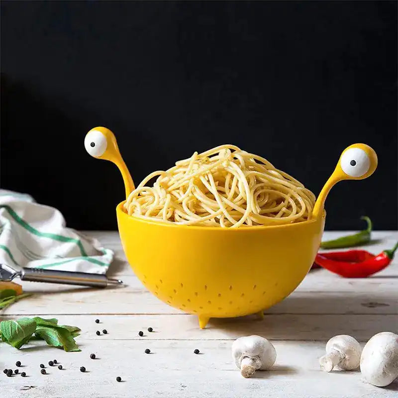 OTOTO Draining Basket for Kitchen filled with spaghetti, featuring a whimsical monster design perfect for meal prep and pasta draining.