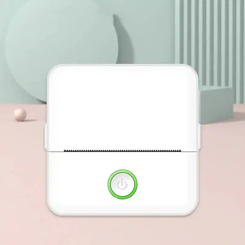 White portable thermal printer displayed in a minimalist setting, featuring a green power button.