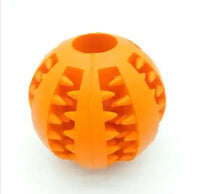 Orange interactive rubber slow feeder dog ball with textured grooves for treat dispensing and chewing fun.