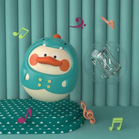 Blue Montessori baby tumbler toy with a duck face, surrounded by colorful musical notes, promoting auditory and visual stimulation.