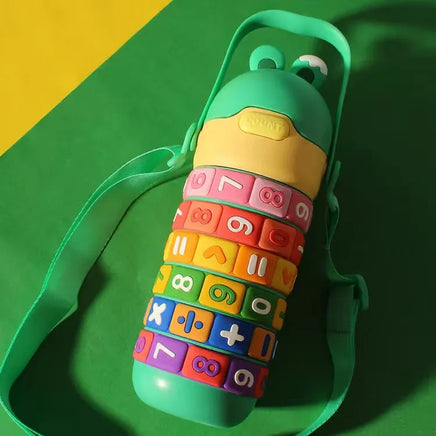 Green Children's Creative Educational Tumbler with strap, featuring vibrant rotating rings with numbers and symbols for learning.