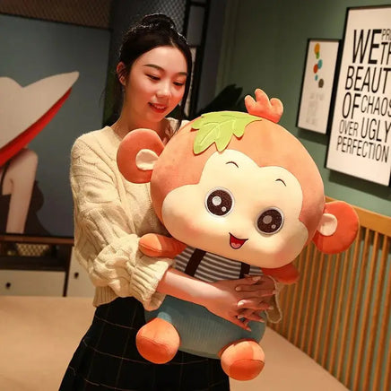 Woman holding a large orange Sitting Monkey Plush Toy with a cheerful expression, perfect for cuddling.