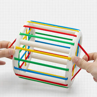 Baby Blocks Shape Sorter Toy with colorful elastic bands and a cylindrical design, perfect for developing fine motor skills in toddlers.