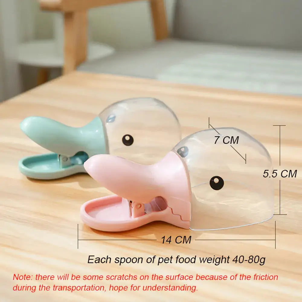 Pet Food Spoon with clip design in pink and green, featuring a duck-shaped scoop for easy pet food portioning. Dimensions and weight details included.