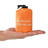 Compact orange waterproof reusable emergency sleeping bag displayed on a hand, highlighting its lightweight and portable design.