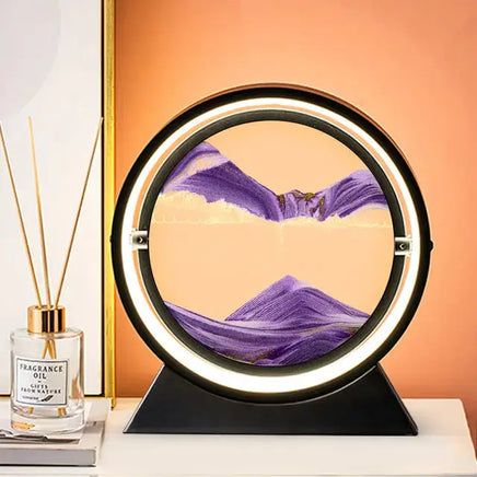 Moving Sand Art Picture Frame featuring purple sand forming intricate landscapes in a circular frame with LED lighting, placed on a black base.