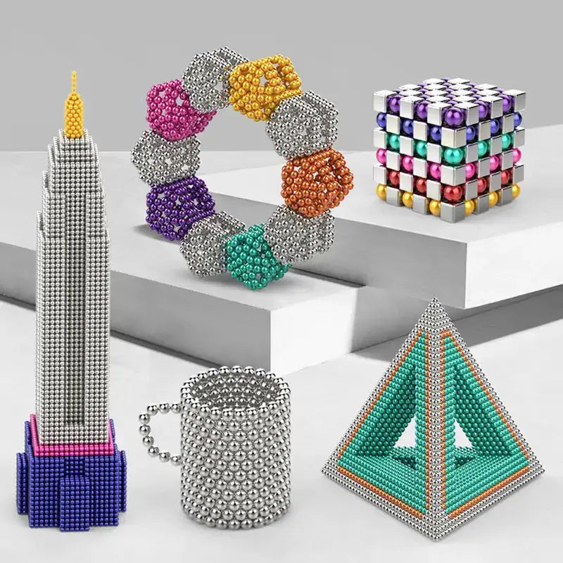 Creative shapes made from magnetic metal balls, including a tower, mug, pyramid, and bracelet, demonstrating endless design possibilities.