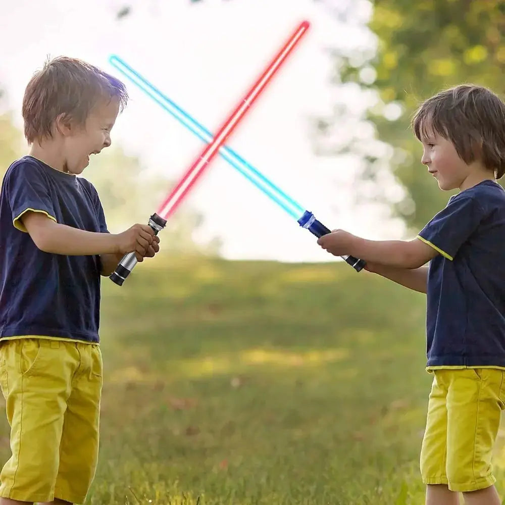 Two children playing with red and blue lightsaber toys outdoors, sparking imaginative and active fun.