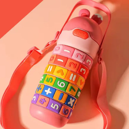 Pink Children's Creative Educational Tumbler with strap and colorful rotating rings, combining fun and education for kids.