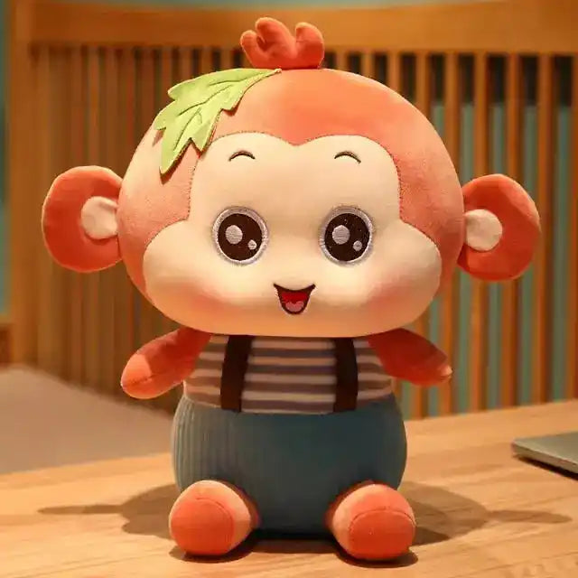 Adorable sitting monkey plush toy with a cheerful expression, striped shirt, blue pants, and a leaf detail on its head, perfect for all ages.