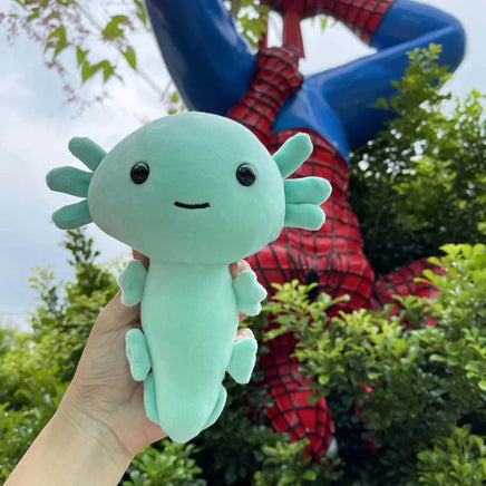 Mint green anime axolotl plush toy held outdoors with a superhero statue in the background, great for anime lovers.