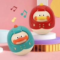 Montessori baby tumbler toys in red and blue designs with duck faces, featuring a wobbling motion and musical notes for sensory play.