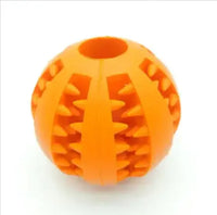 Orange interactive rubber slow feeder dog ball with textured grooves for treat dispensing and chewing fun.