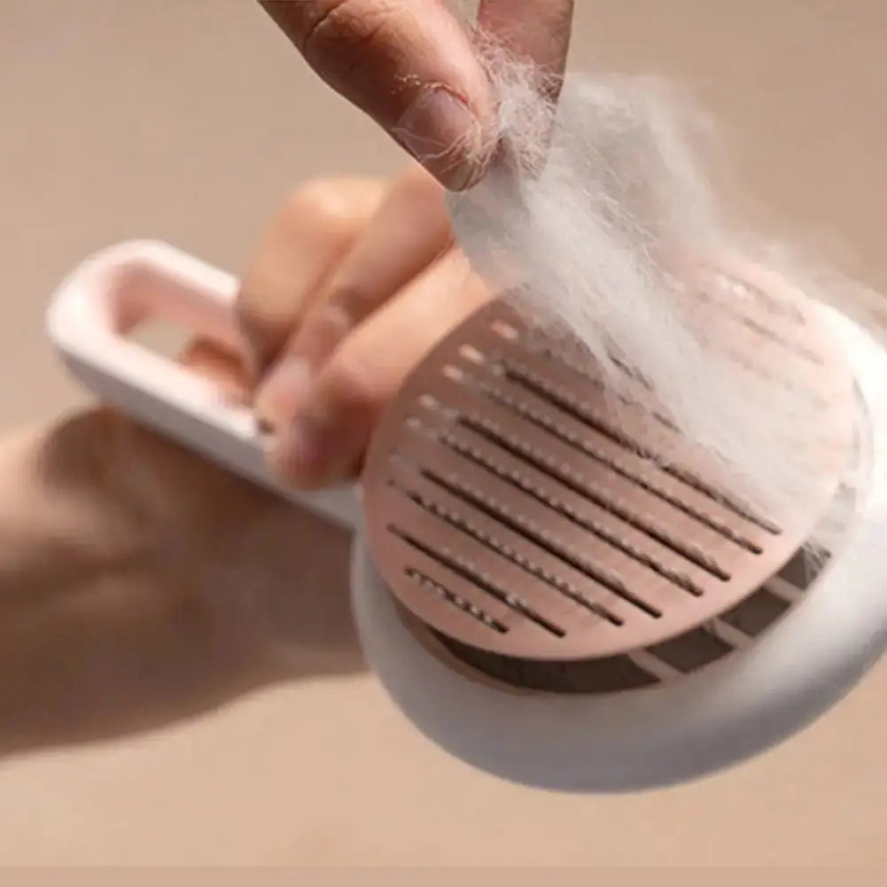 Hand peeling off collected pet hair from the pink Automatic Hair Remover & Massage Comb, highlighting its easy cleaning feature.