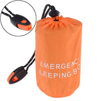 Close-up of the orange waterproof reusable emergency sleeping bag with a whistle attached to the black drawstring for added safety.